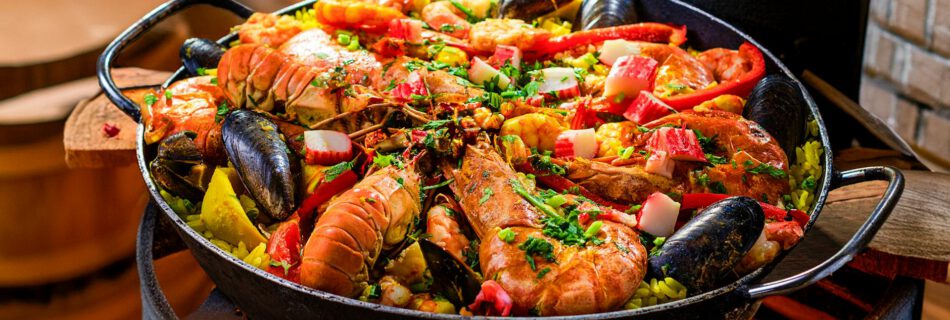 vibrant seafood paella cooking over open flame