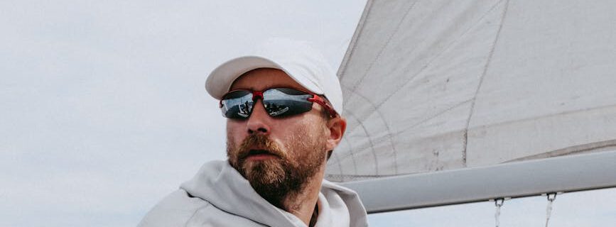man in white hoodie wearing black sunglasses